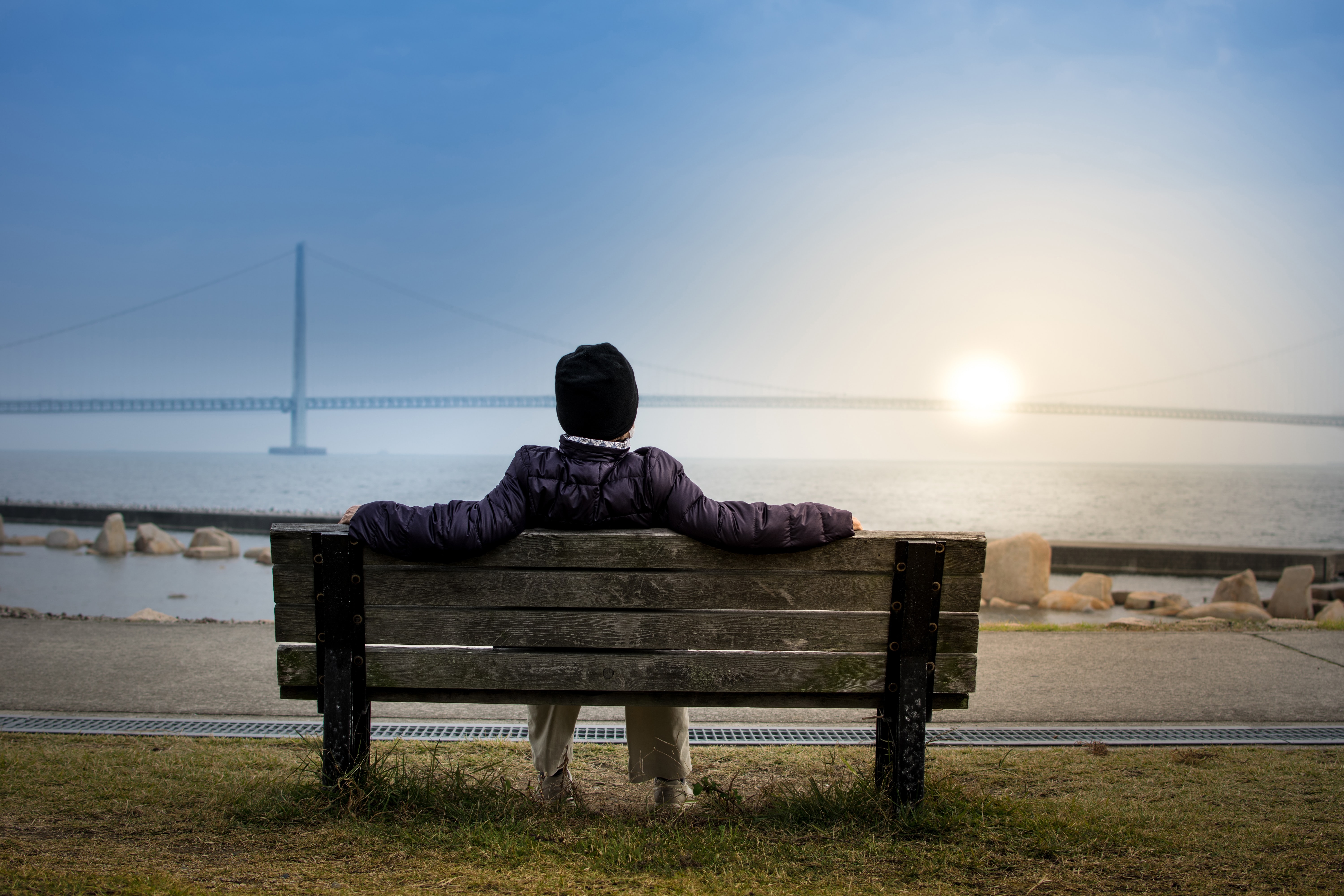Women looks over the water at sunset